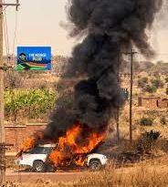 MOURNERS SCRAMBLE TO RETRIEVE COFFIN AS HEARSE CATCHES FIRE