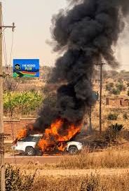 MOURNERS SCRAMBLE TO RETRIEVE COFFIN AS HEARSE CATCHES FIRE MOURNERS SCRAMBLE TO RETRIEVE COFFIN AS HEARSE CATCHES FIRE