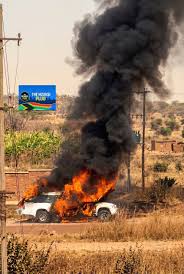 MOURNERS SCRAMBLE TO RETRIEVE COFFIN AS HEARSE CATCHES FIRE MOURNERS SCRAMBLE TO RETRIEVE COFFIN AS HEARSE CATCHES FIRE